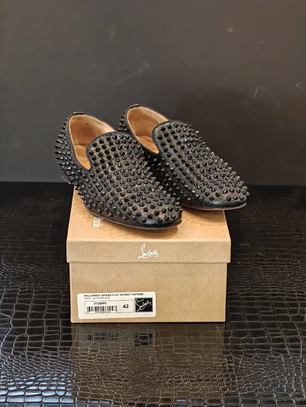 Christian Louboutin Rollerboy Spikes loafers in black patent leather, sized 42.